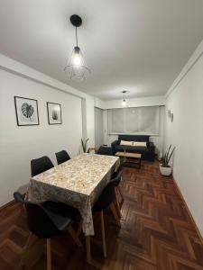 a living room with a table and chairs and a bed at Balcones del Calicanto in Córdoba