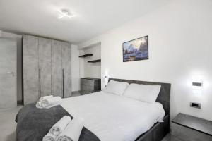 a bedroom with a large bed with white sheets at perla in Aosta
