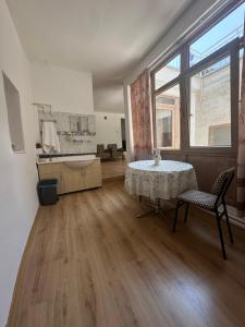 a large room with a table and a sink and a window at Ayten Hanım Konağı in Ürgüp