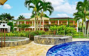 a resort with two pools in front of a building at Hotel Campestre Cafe Cafe in Montenegro +89 photos