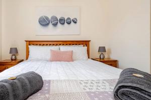 a bedroom with a large bed with two night stands at The Fairways in Portsmouth