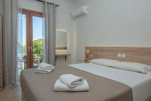 Postel nebo postele na pokoji v ubytování Athina Villas