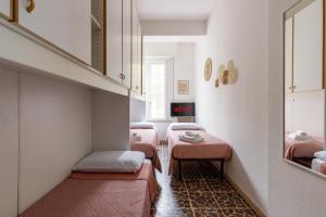 a small room with three beds and a staircase at Marina Dream 200 Meters From The Sea in Marina di Ravenna