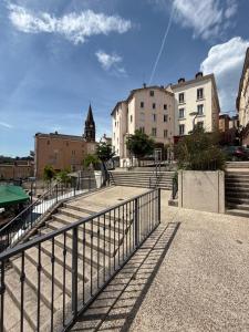 a group of stairs in a city with buildings at T2 lumineux et tout équipé centre Annonay in Annonay