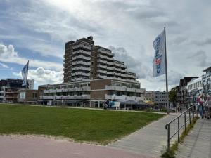 a large building with two flags in front of it at Panorama Whg 73, 5 OG in Cuxhaven