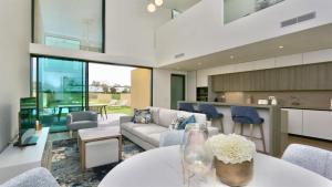 a living room with a couch and a table at Villa Rimah, Sunny Algarve, Entire Villa "heated" pool, Golf, walk to Beaches & Long Stays by Clever Details in Vilamoura