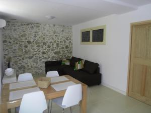 a living room with a black couch and a table at La Ferronnerie Cassis centre in Cassis +7 photos