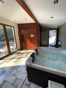 a large bathroom with a large soaking tub at Planinska idila in Crni Vrh +49 photos