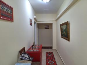a hallway with a red table in a room at Apartment Majlinda in Tirana