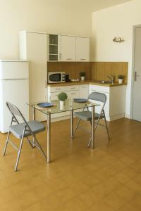 a kitchen with a table and two chairs and a counter at Quiet studio for 4 people area Jacobins-Bellecour in Lyon