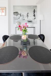 a table with a vase of flowers on it at Outstanding Apartment-Near Disneyland Paris in Chessy