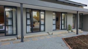 a house with a row of windows on it at Grootboom Guest Rooms in Pretoria +9 photos