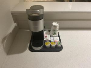a coffee maker sitting on a counter with muffins at Holiday Inn Houston Intercontinental Airport by IHG in Houston