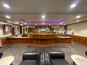 a waiting room with a bar with purple lighting at AKG Lodge in Kanchipuram