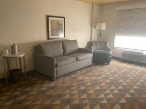 a living room with a couch and a chair at Holiday Inn Houston Intercontinental Airport by IHG in Houston