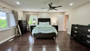 a bedroom with a bed and a ceiling fan at Massive Luxury Retreat with Gym, Sauna, Games and More in Mississauga