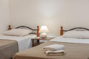 Postel nebo postele na pokoji v ubytování Athina Villas
