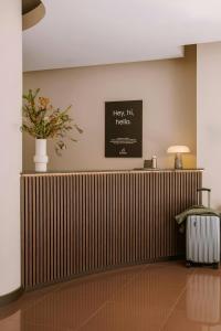 a lobby with a radiator and a vase of flowers at The Gilbert Hotel Kensington, Sonder Hotel by Marriott Bonvoy in London