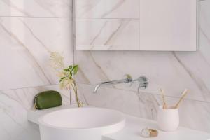 a white bathroom with a sink and a mirror at Atala Hotel Champs Elysées, Sonder by Marriott Bonvoy in Paris