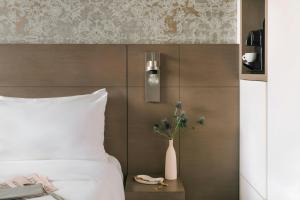 a bedroom with a bed and a vase on a table at Atala Hotel Champs Elysées, Sonder by Marriott Bonvoy in Paris
