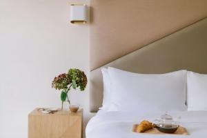 a hotel room with a bed with a tray of food at Atala Hotel Champs Elysées, Sonder by Marriott Bonvoy in Paris