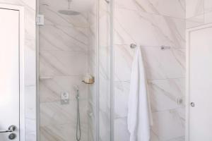 a bathroom with a shower with a glass door at Atala Hotel Champs Elysées, Sonder by Marriott Bonvoy in Paris
