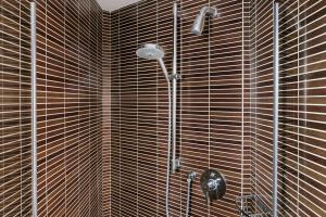 a bathroom with a shower with a shower head at Atala Hotel Champs Elysées, Sonder by Marriott Bonvoy in Paris