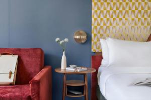 a bedroom with a bed and a table and a chair at Atala Hotel Champs Elysées, Sonder by Marriott Bonvoy in Paris