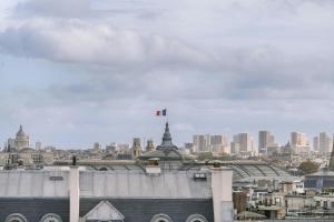 a view of a city with a flag on top of a building at Atala Hotel Champs Elysées, Sonder by Marriott Bonvoy in Paris