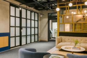 a living room with a couch and a table at Sonder by Marriott Bonvoy Artesa Apartments West Queen West in Toronto