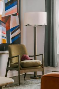 a living room with a chair and a lamp at Nester Finn Square Victoria in Montreal +68 photos
