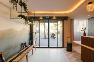 a lobby with benches and a door with a bike in the background at Yelo Promenade Hotel Magnan, Sonder by Marriott Bonvoy in Nice +30 photos