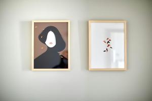 two framed illustrations of a woman on a wall at Hotel Vasanta in Barcelona