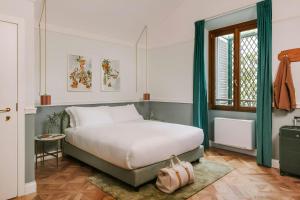 a bedroom with a bed and a window at Bob W Florence Santa Croce in Florence +57 photos
