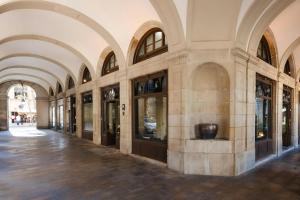 a building with arched ceilings and a hallway with windows at DO Plaça Reial Hotel Gothic Quarter, Sonder by Marriott Bonvoy in Barcelona