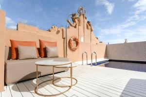 a balcony with a couch and a table on a building at DO Plaça Reial Hotel Gothic Quarter, Sonder by Marriott Bonvoy in Barcelona