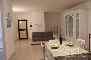 a living room with a table and a couch at Casa Coronas-Domo de zizzi in Orosei