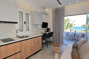 a kitchen with a view of the ocean at Morpheas Rooms in Palaiochora