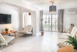 a living room with a couch and a table at Chic Villa with pool, garden and parking REMS in Fuengirola