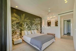 Ένα ή περισσότερα κρεβάτια σε δωμάτιο στο Luxueux appartement sur sa plage privée