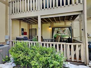 a porch of a house with a wooden railing at Innsbrook 254 in Ruidoso
