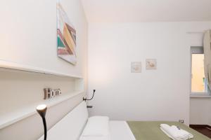 a white room with a table and a window at Ostia Bella Apartment in Lido di Ostia +69 photos