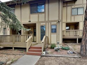 a house with a porch and stairs in front of it at Innsbrook 254 in Ruidoso
