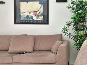 a couch in a living room with a painting on the wall at Piazzetta Signori By Case al Lago in Desenzano del Garda +19 photos