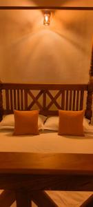 a bed with two pillows on top of it at Holiday Home Ragama in Ragama