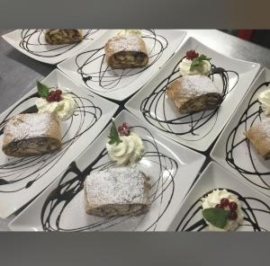 a bunch of desserts on plates on a table at Old Car's Hotel in Selpritsch +4 photos