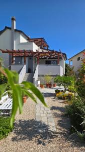 a house with a pathway leading up to it at Apartman Luce in Krk