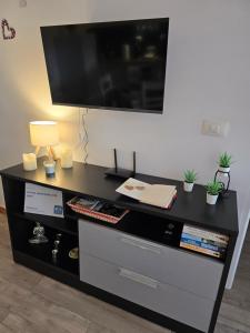 a black desk with a tv on a wall at Lovely apartment with pool in Costa Del Silencio