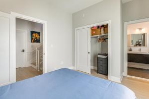ワシントンにあるWalkable Columbia Heights Condo with Rooftop Deck!のベッドルーム(青いベッド1台付)、バスルーム