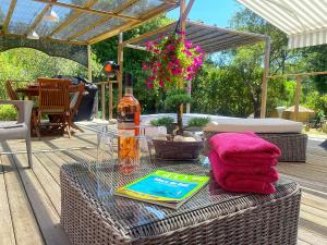 a table with a bottle of wine and a towel at Délice du maquis Corse in Porto-Vecchio
